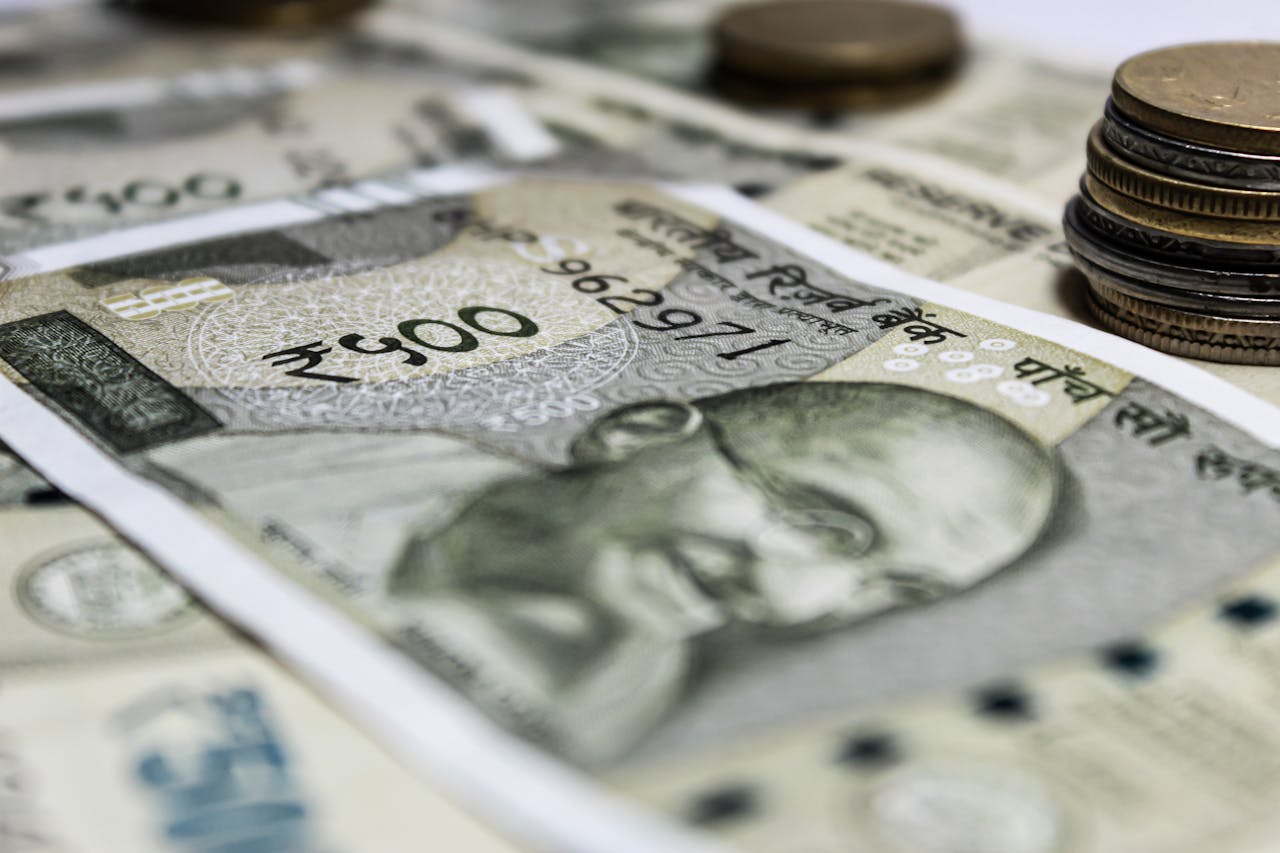 about-us Detailed close-up of Indian rupees and coins, symbolizing economy and finance.
