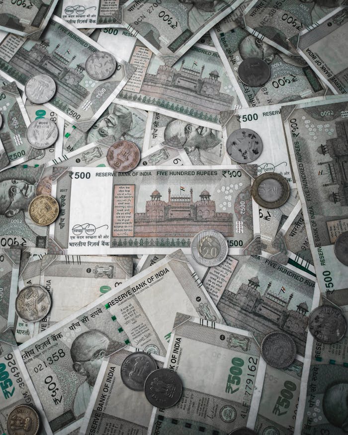 who-we-are A detailed flat lay of various Indian rupee banknotes and coins, showcasing currency diversity.